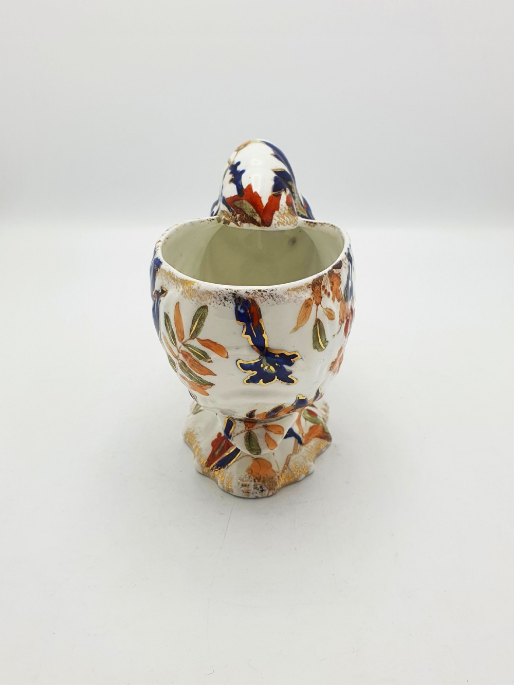 A late Victorian Ridgways china spoon warmer in the shape of a nautilus shell with cobalt blue, terracotta orange floral details, and gilded trim. View III