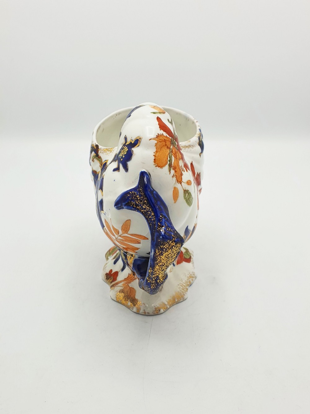 A late Victorian Ridgways china spoon warmer in the shape of a nautilus shell with cobalt blue, terracotta orange floral details, and gilded trim. View VI