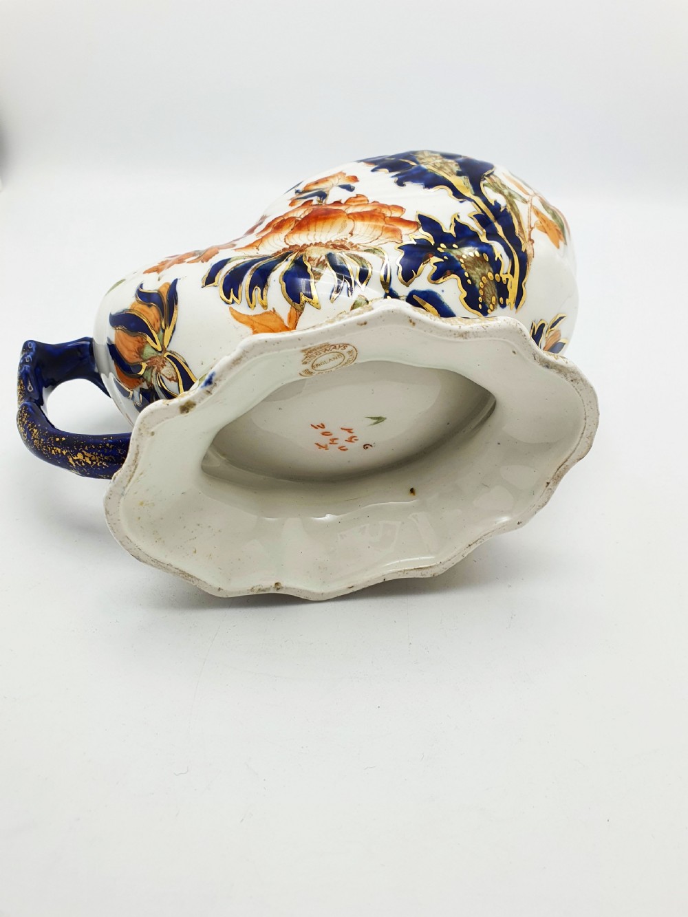 A late Victorian Ridgways china spoon warmer in the shape of a nautilus shell with cobalt blue, terracotta orange floral details, and gilded trim. View VIII