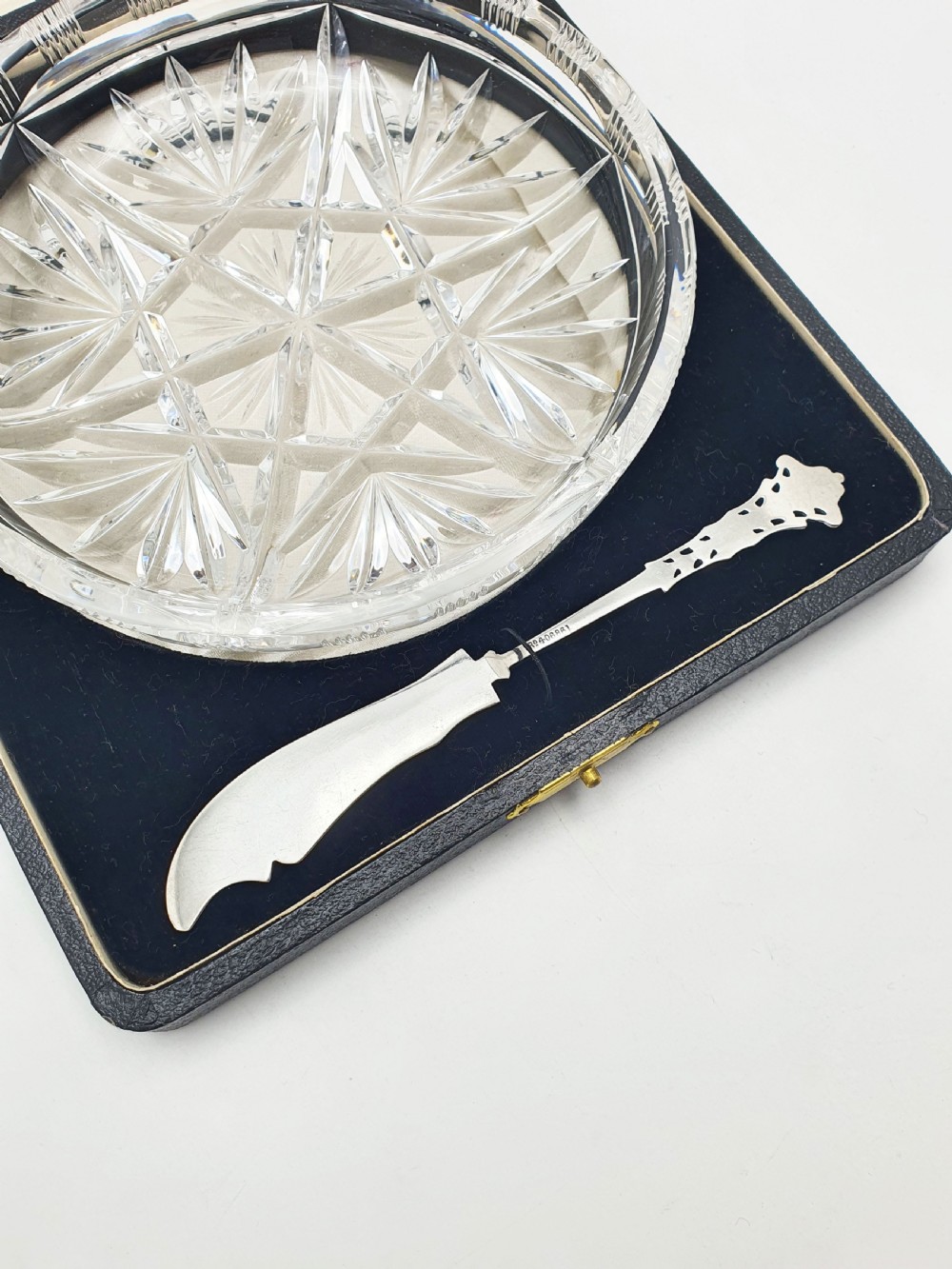 A circular cut crystal butter dish and a hallmarked sterling silver spreader presented inside a fitted black box. View IX