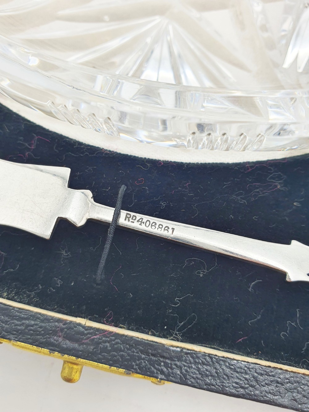 A circular cut crystal butter dish and a hallmarked sterling silver spreader presented inside a fitted black box. View X