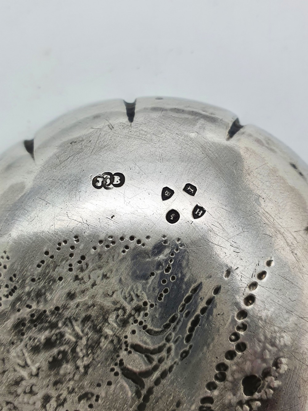 An elongated Victorian sterling silver tray featuring an embossed scene of a dancing couple and a musician surrounded by a fluted border. View V