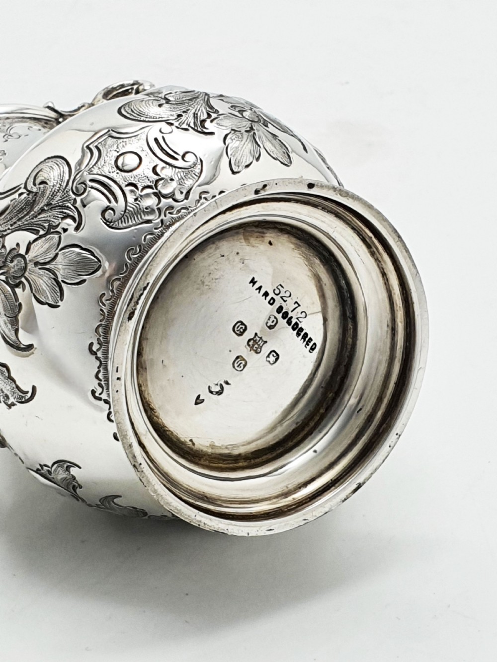 A two-piece Victorian silver-plated set featuring a milk jug and a double-handled sugar bowl, both decorated with intricate repousse floral scrollwork and lined with a gilded interior. View XIV