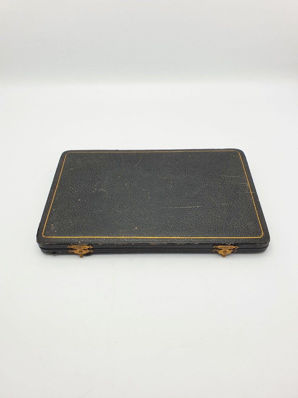 A cased set of six silver-plated lobster picks displayed inside a dark blue velvet-lined presentation box. View VII