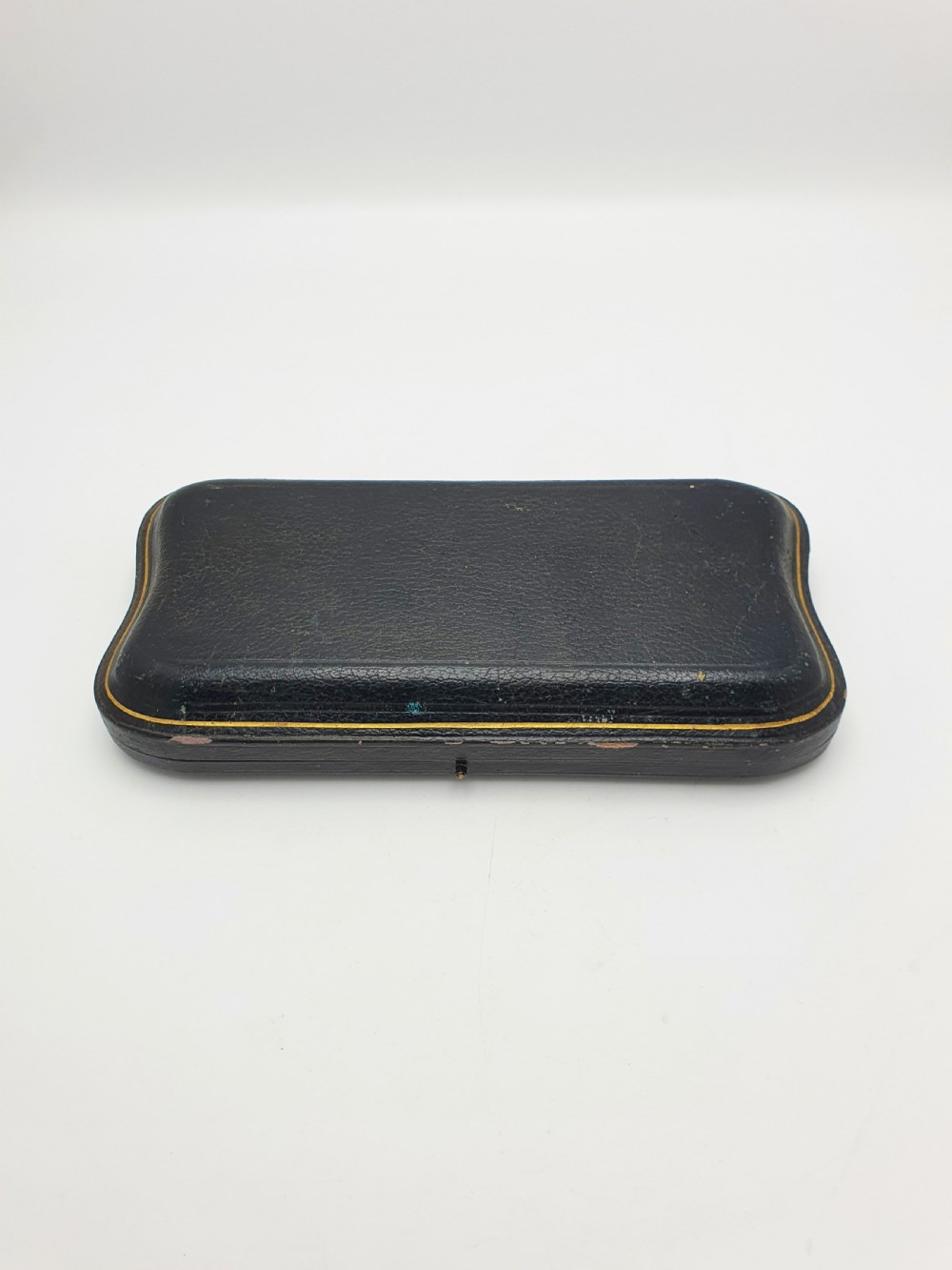 A pair of 1910 sterling silver serving spoons with gilt oval bowls presented inside a dark blue velvet-lined case. View VII