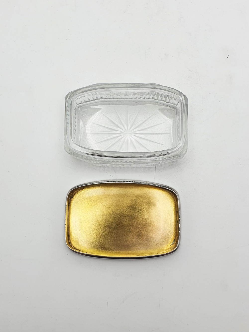 A rectangular clear etched glass dressing table jar topped with a sterling silver rim and a bright green guilloche enamel lid. View IX