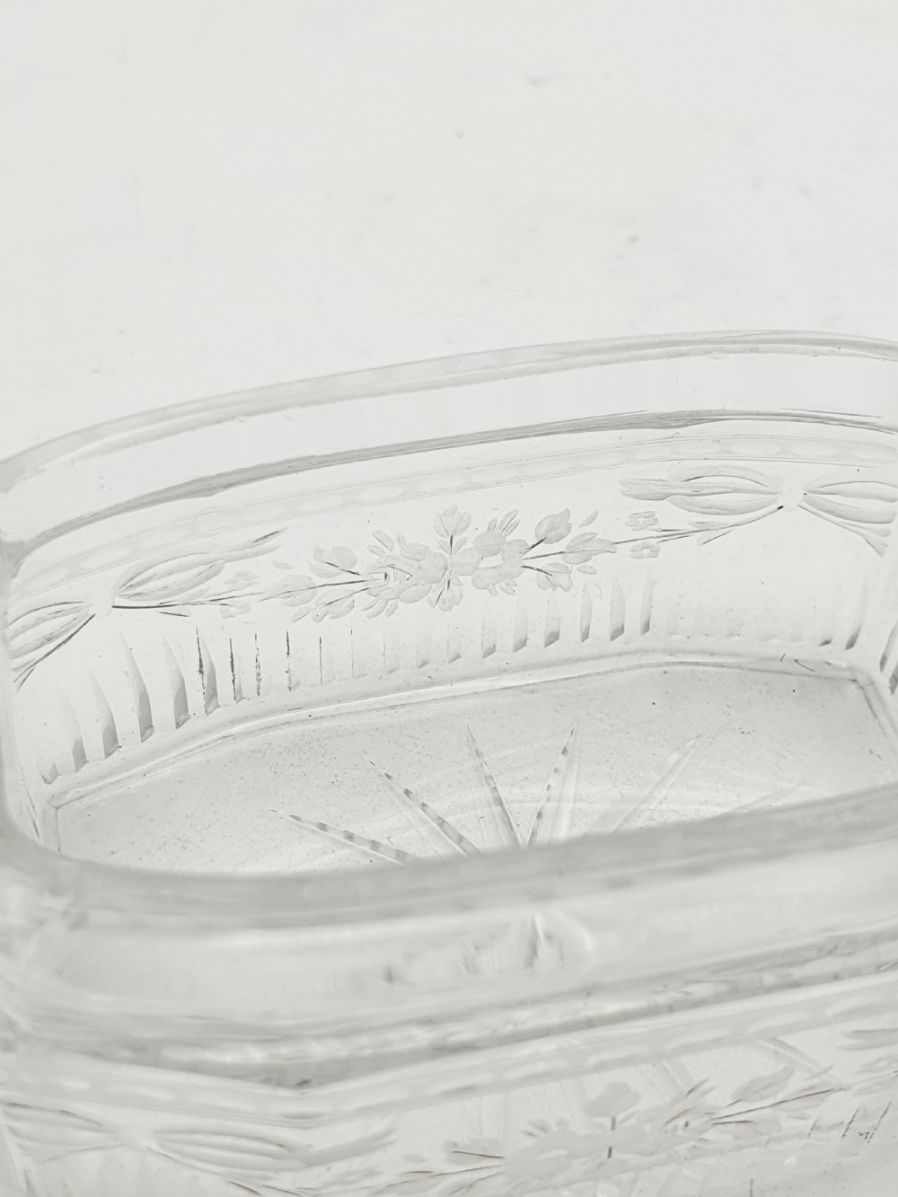 A rectangular clear etched glass dressing table jar topped with a sterling silver rim and a bright green guilloche enamel lid. View X