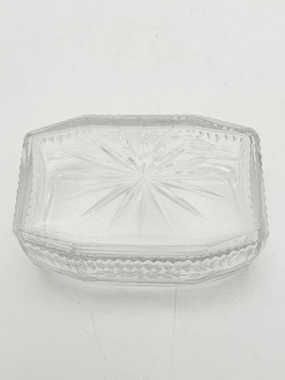 A rectangular clear etched glass dressing table jar topped with a sterling silver rim and a bright green guilloche enamel lid. View XI