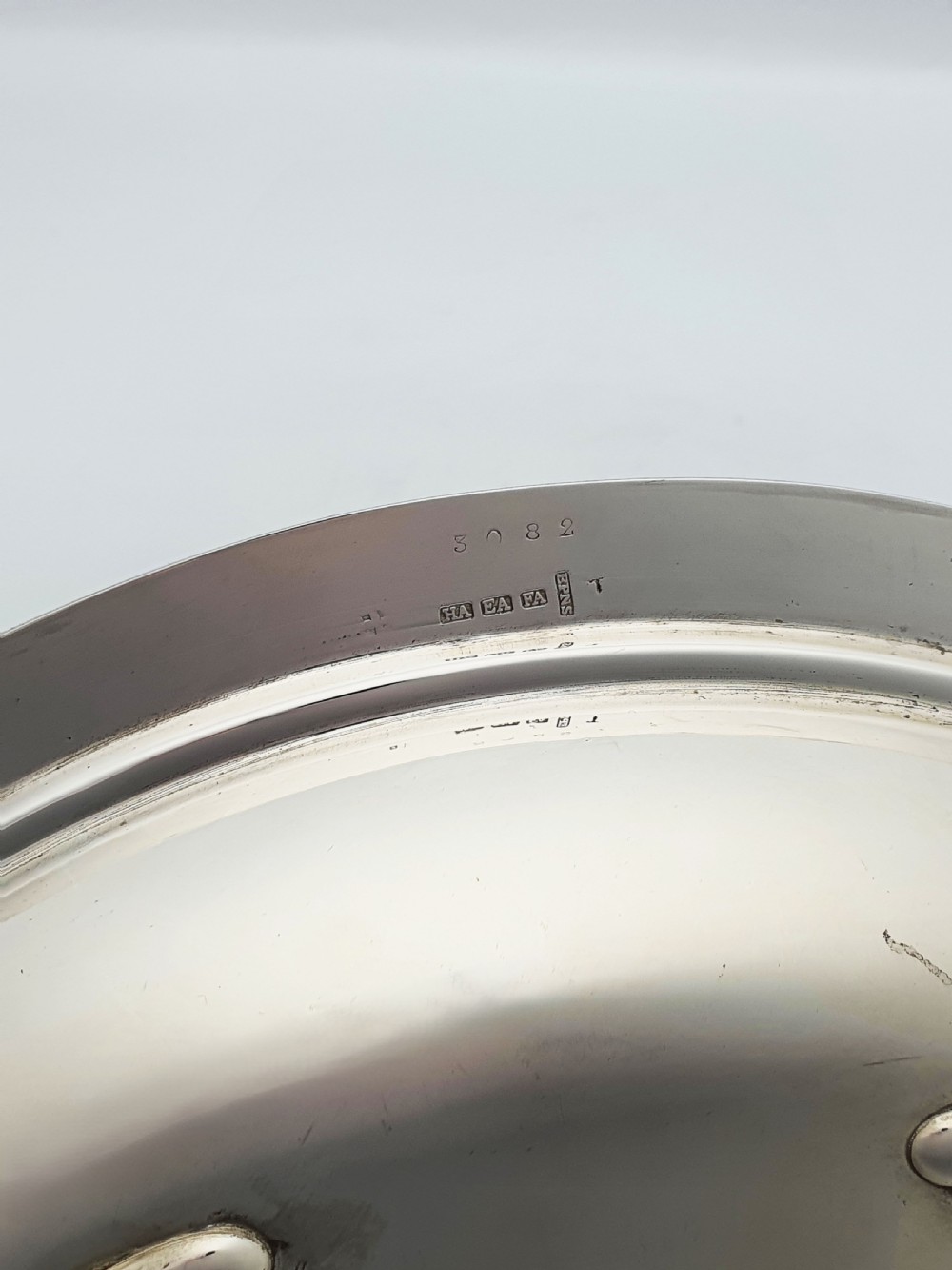 A late Victorian oval silver-plated rollover dish featuring bright-cut botanical engravings, a beaded rim, and side pivot handles. View X
