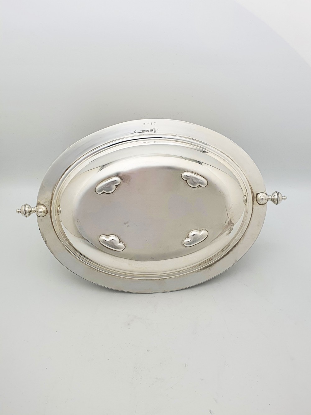 A late Victorian oval silver-plated rollover dish featuring bright-cut botanical engravings, a beaded rim, and side pivot handles. View XIII