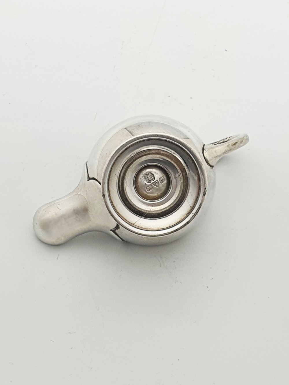 A sterling silver table lighter crafted in the shape of a classical Roman oil lamp with a serpent-shaped handle and pedestal foot. View IX