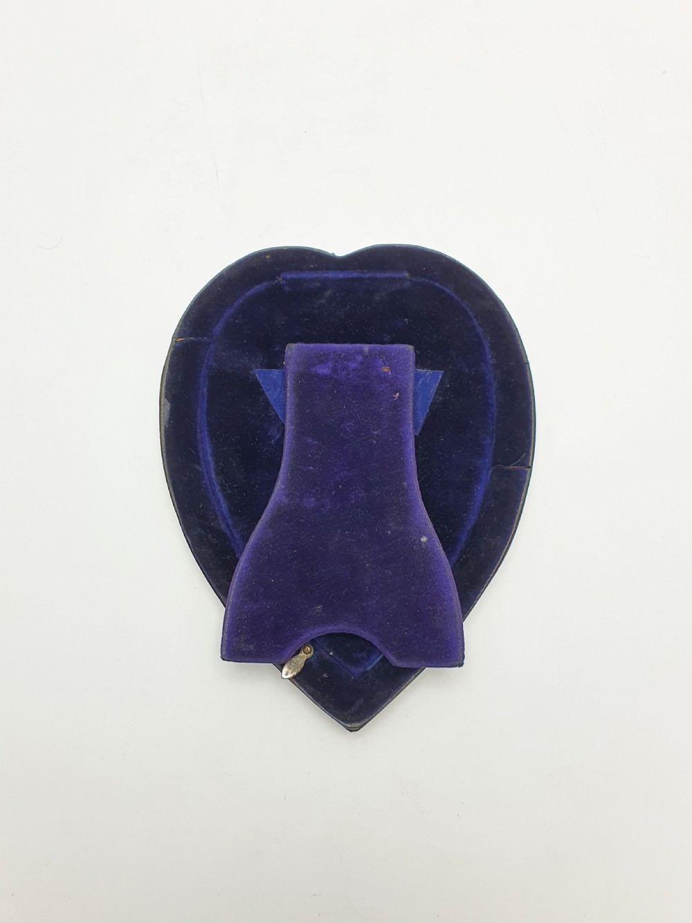 A heart-shaped Edwardian sterling silver picture frame with a smooth polished finish and dark blue display interior. View V