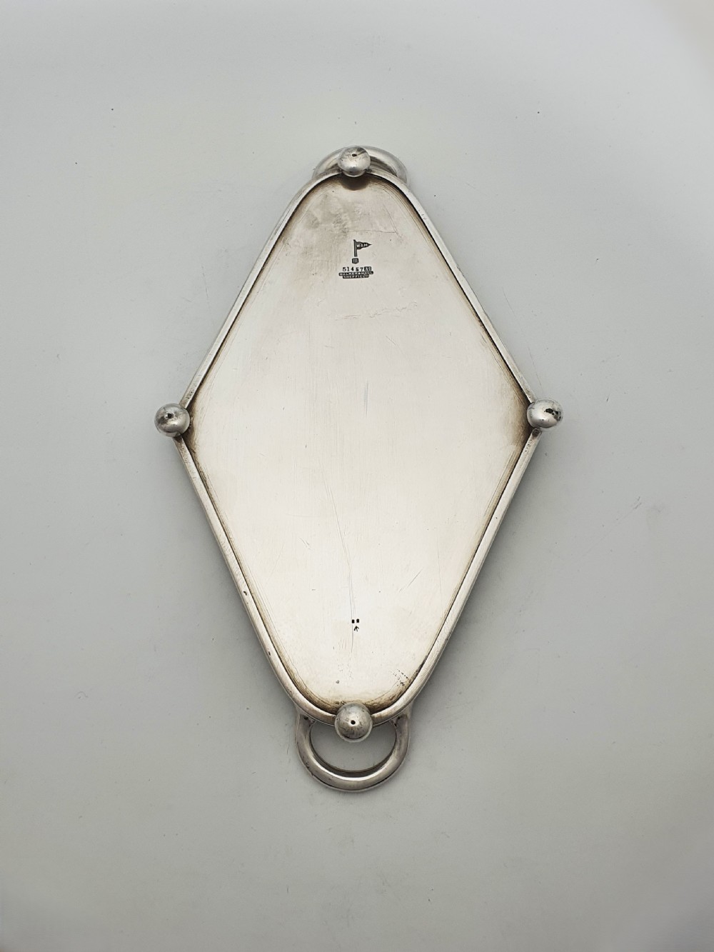 An Art Deco silver-plated tray featuring twin handles and ball feet, holding four fitted clear glass compartments with starburst cut patterns. View VIII