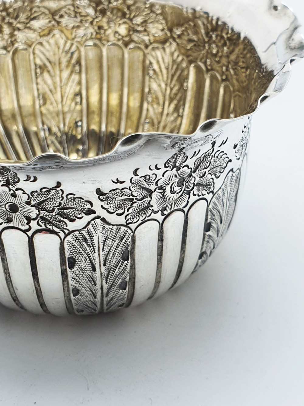 A small Late Victorian sterling silver bowl featuring fluted leaf decoration, floral engraving, a crimped rim, and a gilded interior. View IV