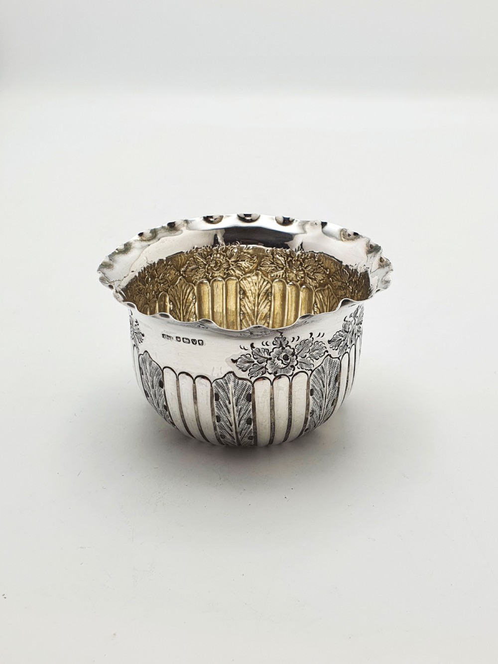 A small Late Victorian sterling silver bowl featuring fluted leaf decoration, floral engraving, a crimped rim, and a gilded interior. View VII