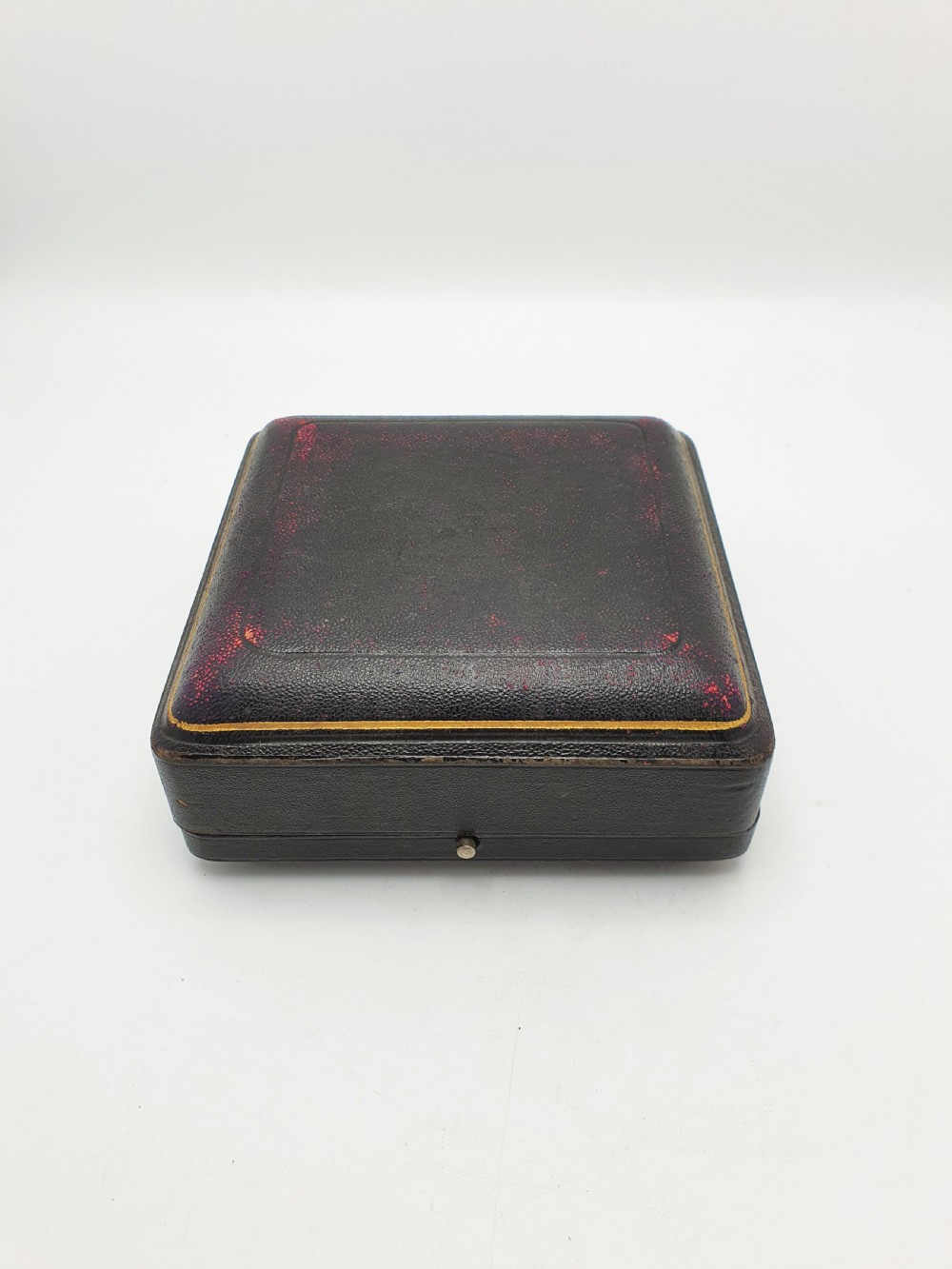 A boxed set of six Edwardian silver-plated napkin rings featuring engraved floral motifs, resting in a blue velvet and silk lined presentation case. View XI