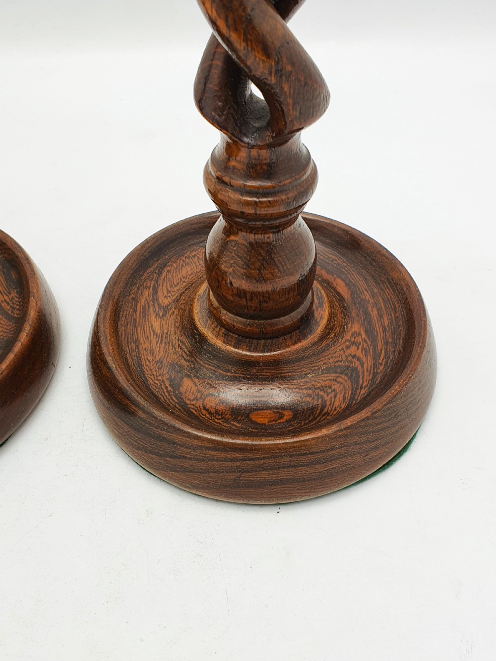 A pair of dark oak candlesticks featuring open barley twist stems and brass sconces atop round dished bases. View III
