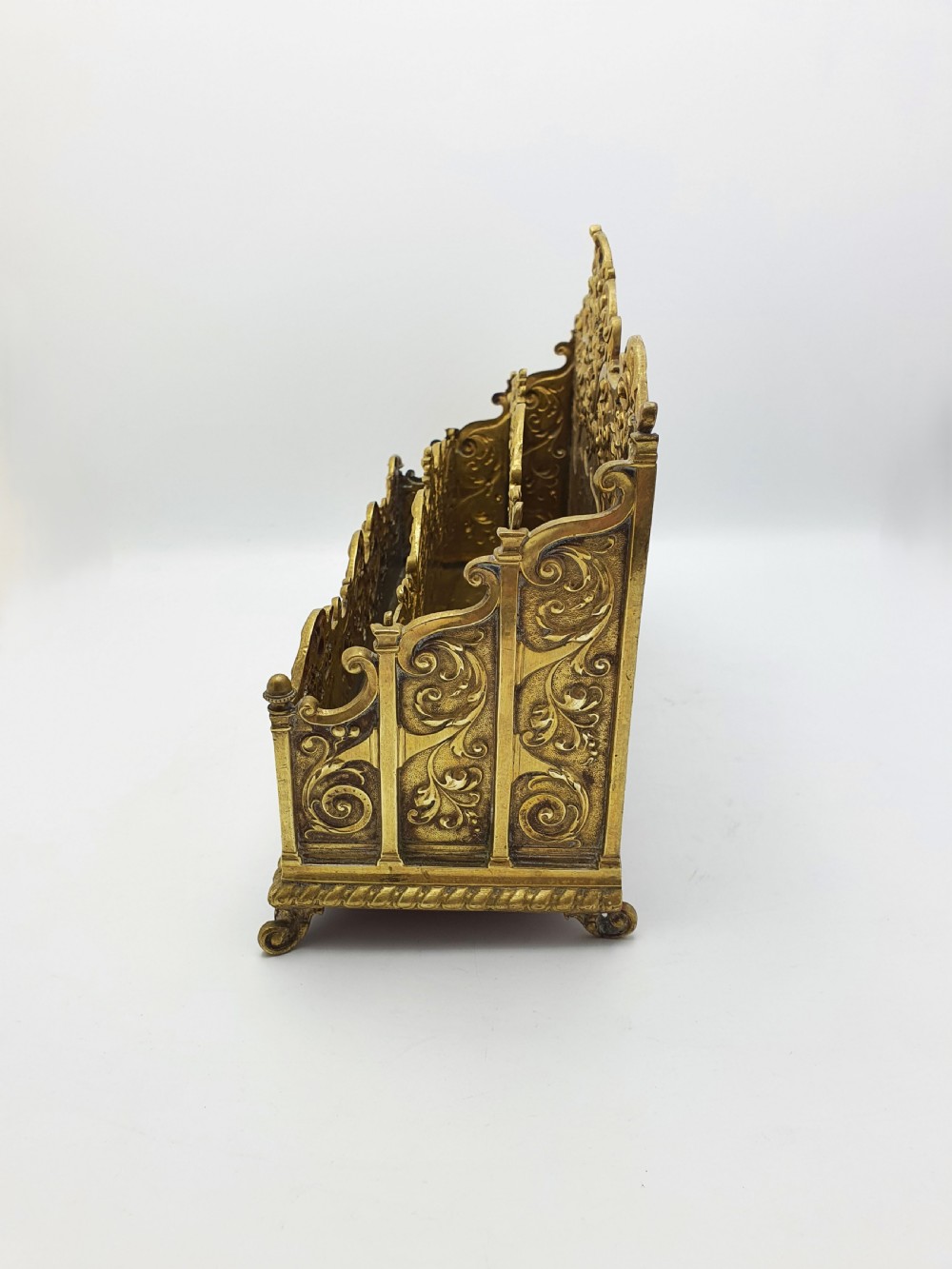 A cast brass Rococo Revival letter rack featuring three tiered compartments with intricate pierced scrollwork and foliate cresting. View VI