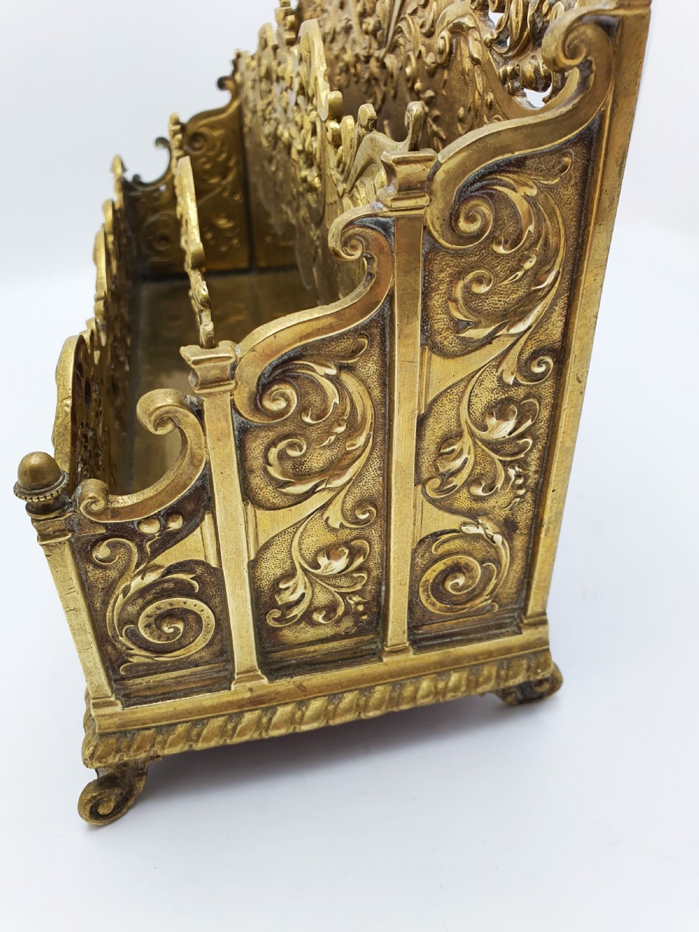 A cast brass Rococo Revival letter rack featuring three tiered compartments with intricate pierced scrollwork and foliate cresting. View VII