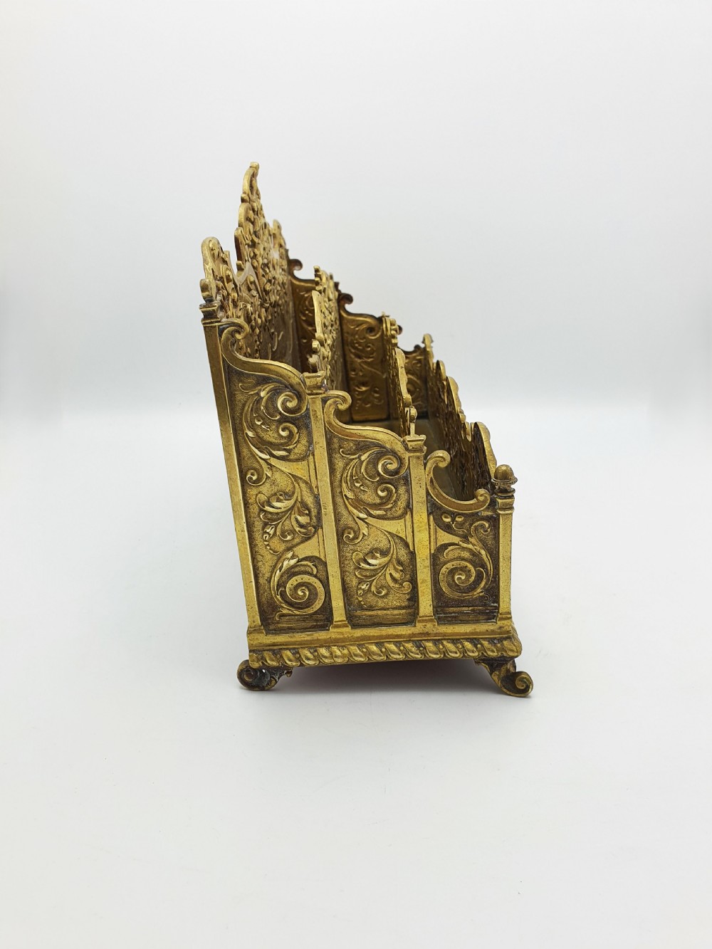 A cast brass Rococo Revival letter rack featuring three tiered compartments with intricate pierced scrollwork and foliate cresting. View IX
