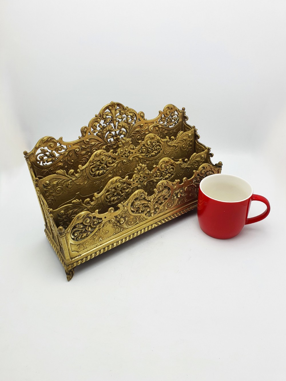 A cast brass Rococo Revival letter rack featuring three tiered compartments with intricate pierced scrollwork and foliate cresting. View XI