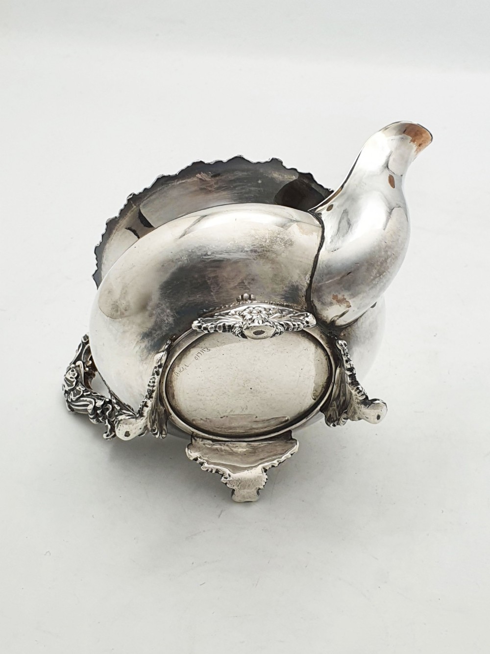 A Georgian silver-plated sugar bowl and matching cream jug with heavily carved scroll rims, double-scroll handles, and gilded interiors. View VIII