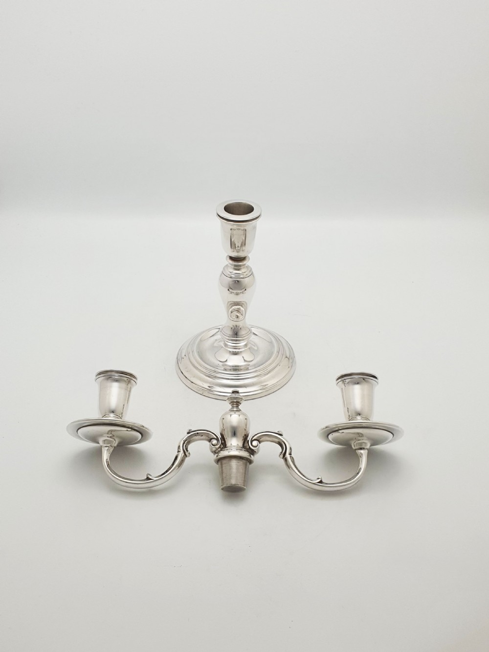 A pair of silver-plated low two-branch candelabra featuring turned central stems, circular stepped bases, and scrolled arms. View IV