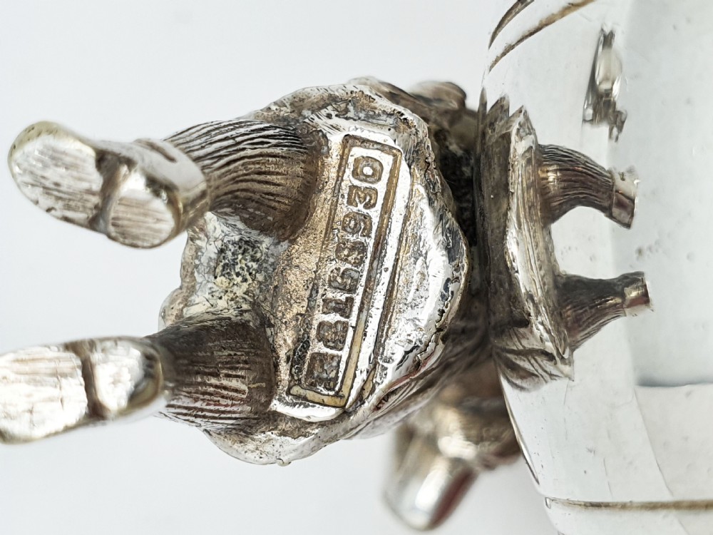 A pair of Victorian silver-plated napkin rings featuring detailed cast figures of young girls wearing bonnets standing beside engraved circular rings. View IX