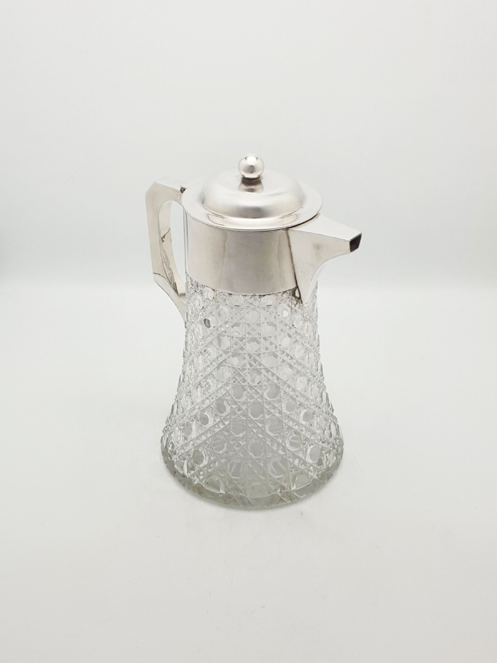 An antique Victorian cut glass lemonade jug featuring a silver-plated hinged lid and spout alongside its removable clear glass ice tube insert. View II