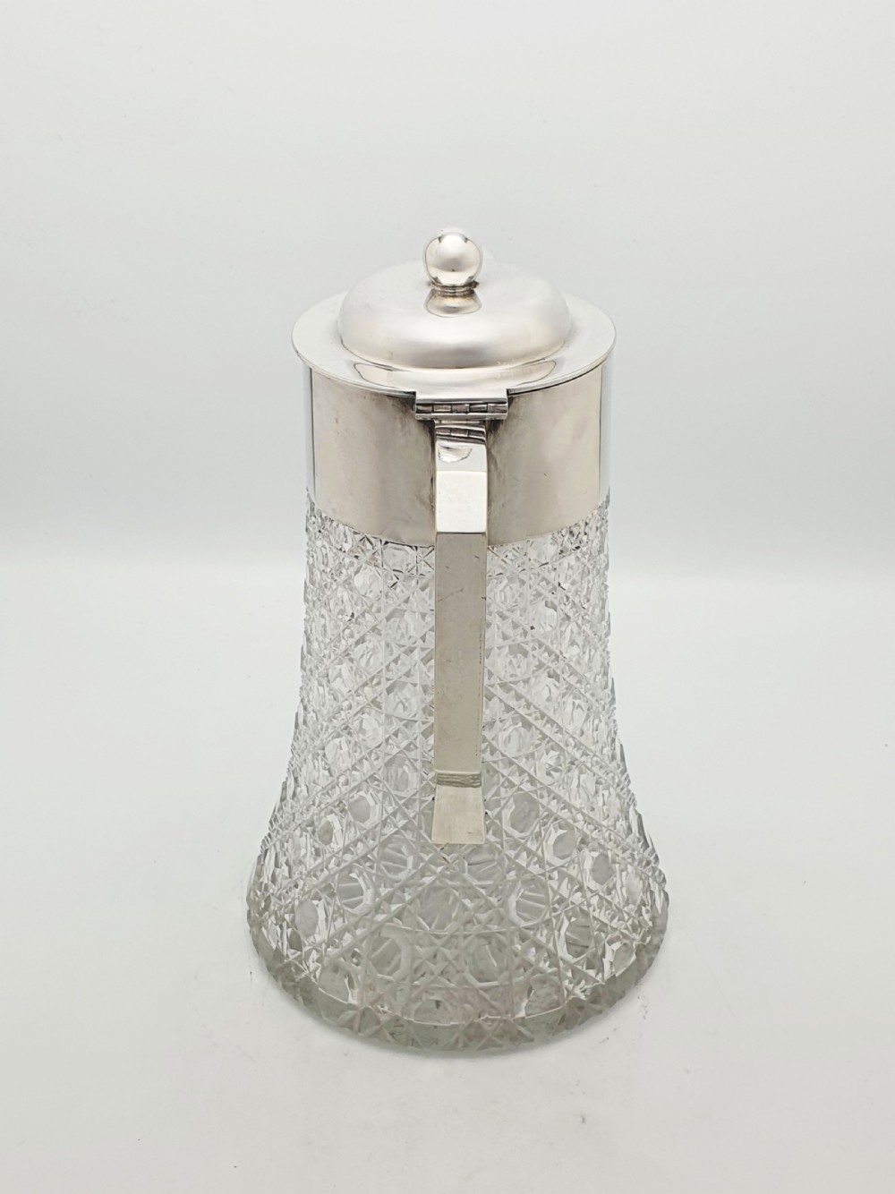 An antique Victorian cut glass lemonade jug featuring a silver-plated hinged lid and spout alongside its removable clear glass ice tube insert. View VII