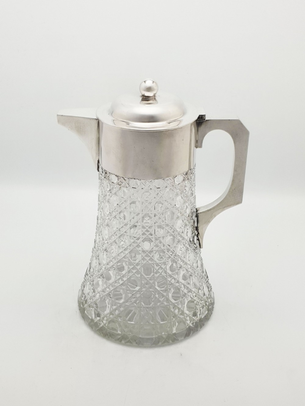 An antique Victorian cut glass lemonade jug featuring a silver-plated hinged lid and spout alongside its removable clear glass ice tube insert. View VIII