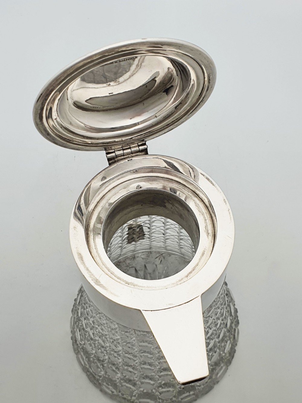 An antique Victorian cut glass lemonade jug featuring a silver-plated hinged lid and spout alongside its removable clear glass ice tube insert. View XI