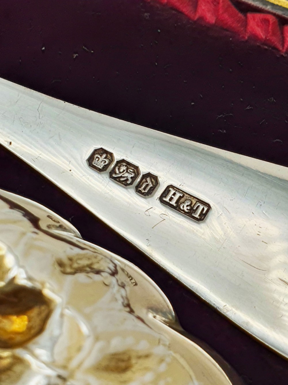 A pair of Victorian sterling silver berry spoons with embossed gilt fruit bowls and engraved handles, presented in a fitted velvet-lined case. View VI