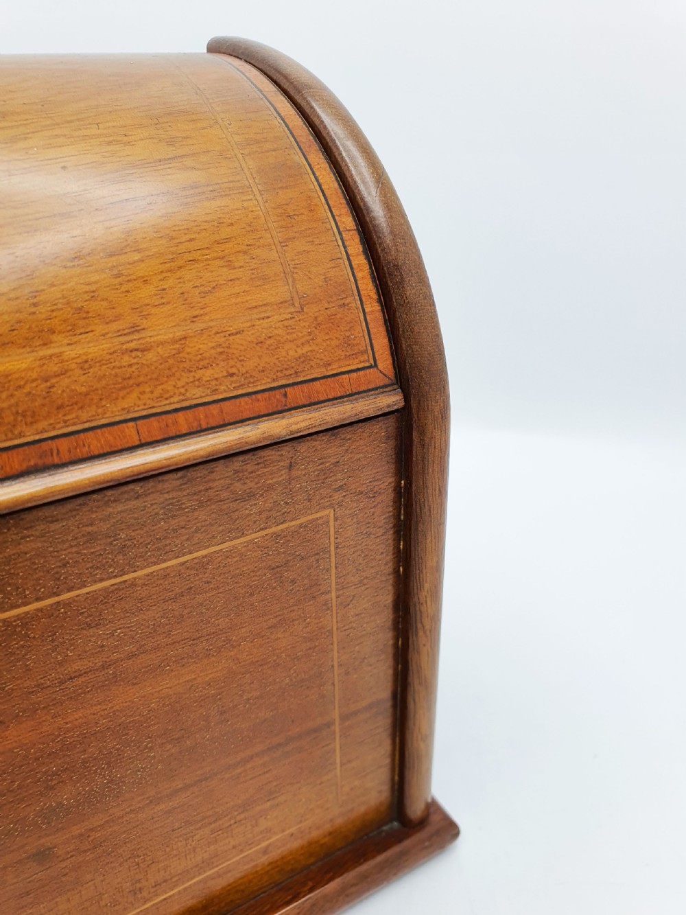 An antique Edwardian mahogany desk tidy featuring a hinged slanted lid, internal letter dividers, and line-inlaid boxwood detail on the front. View III