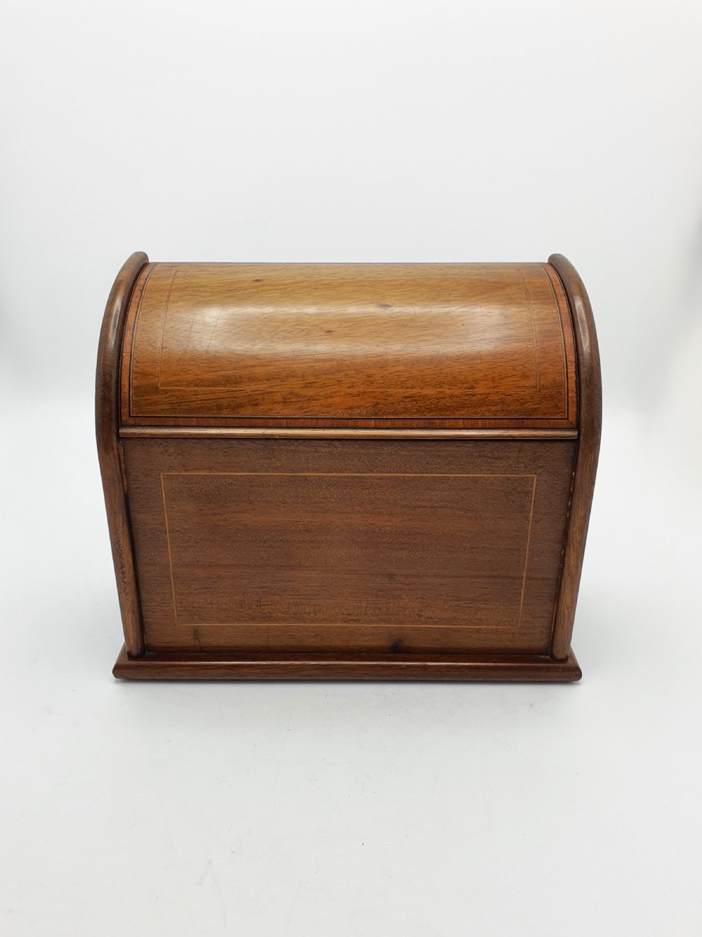 An antique Edwardian mahogany desk tidy featuring a hinged slanted lid, internal letter dividers, and line-inlaid boxwood detail on the front. View V