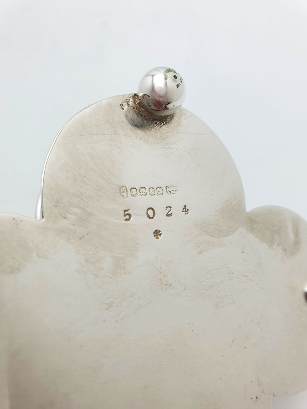 An antique silver-plated condiment caddy holding four faceted cut-glass bottles and pots with silver lids. View XI