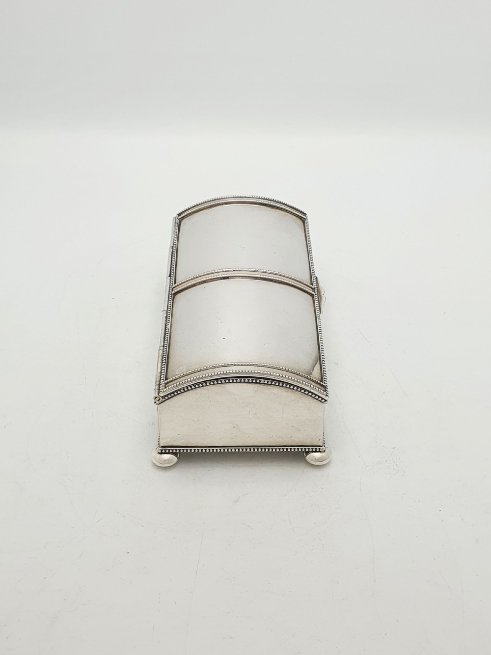 An Edwardian silver-plated rectangular inkstand box featuring a domed hinged lid, beaded border rims, and small ball feet. View VIII