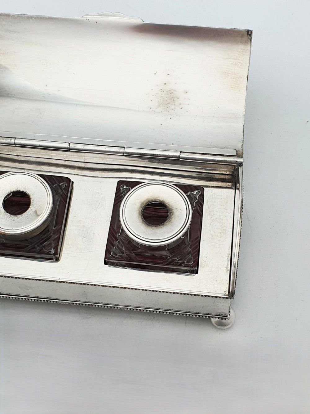An Edwardian silver-plated rectangular inkstand box featuring a domed hinged lid, beaded border rims, and small ball feet. View XI