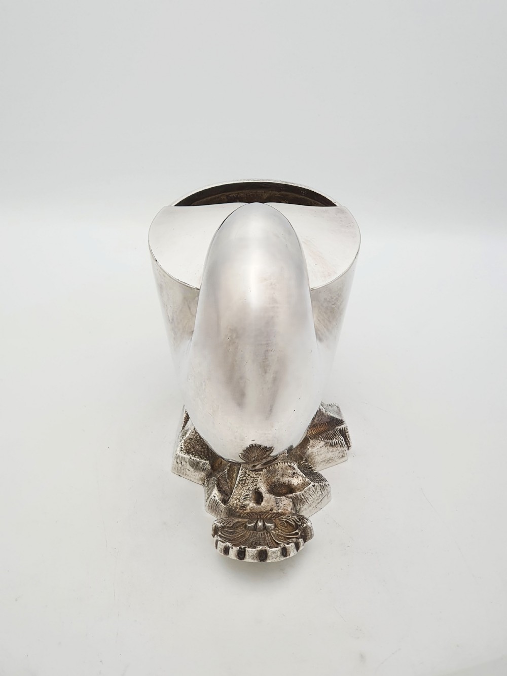 A Victorian silver-plated spoon warmer designed in the form of a nautilus shell mounted on a textured rocky base. View VII