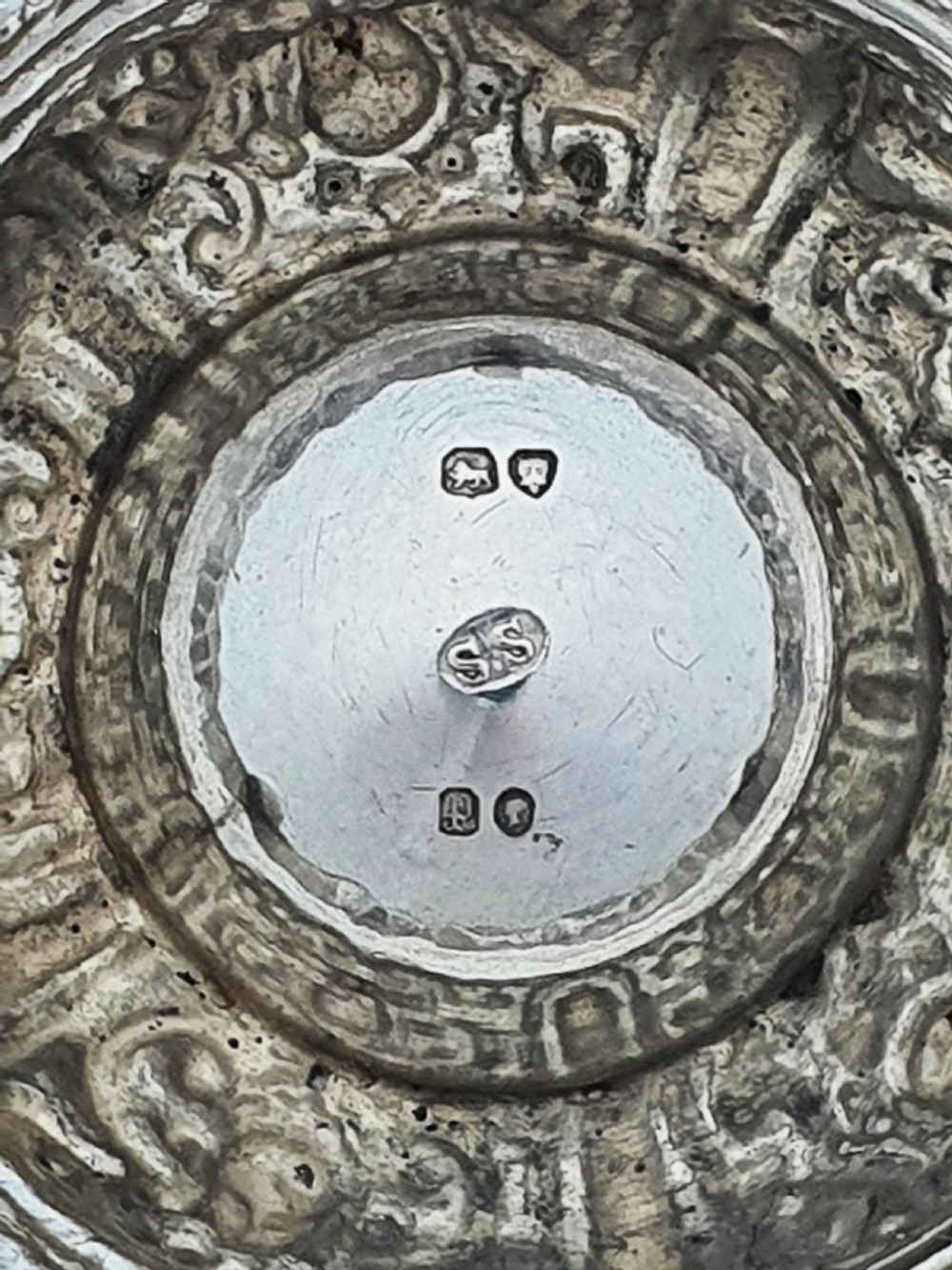 A pair of Victorian sterling silver salt cellars decorated with chased classical masks, foliate wreaths, and tripod feet. View VIII