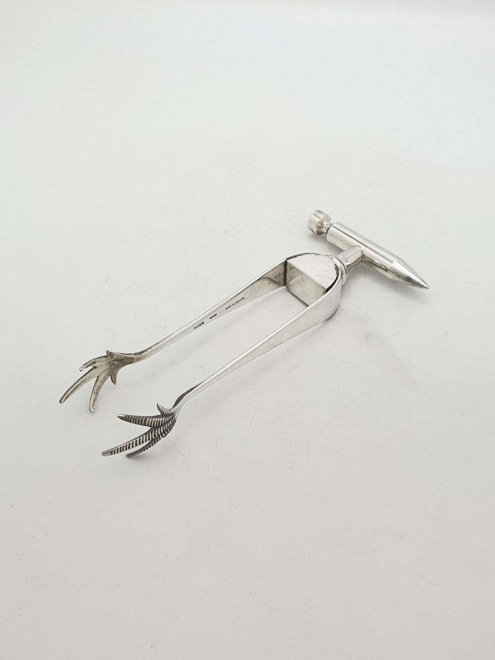 A pair of silver-plated Art Deco ice tongs featuring bird claw grippers and a top-mounted ice pick hammer head. View II