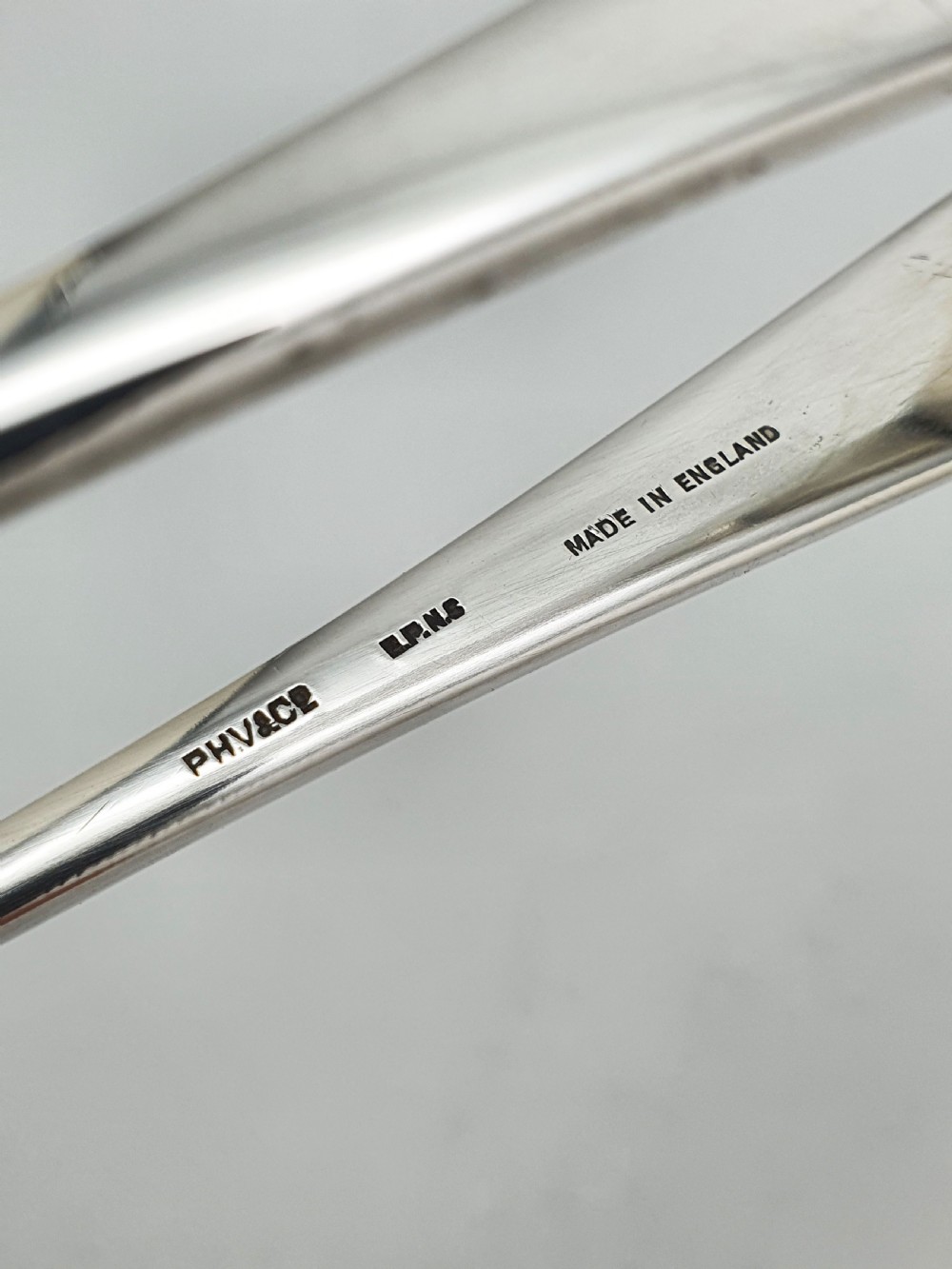 A pair of silver-plated Art Deco ice tongs featuring bird claw grippers and a top-mounted ice pick hammer head. View III