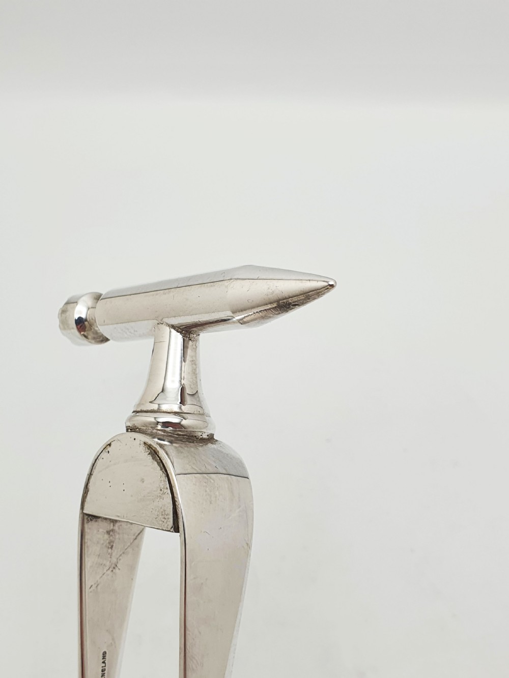 A pair of silver-plated Art Deco ice tongs featuring bird claw grippers and a top-mounted ice pick hammer head. View VI