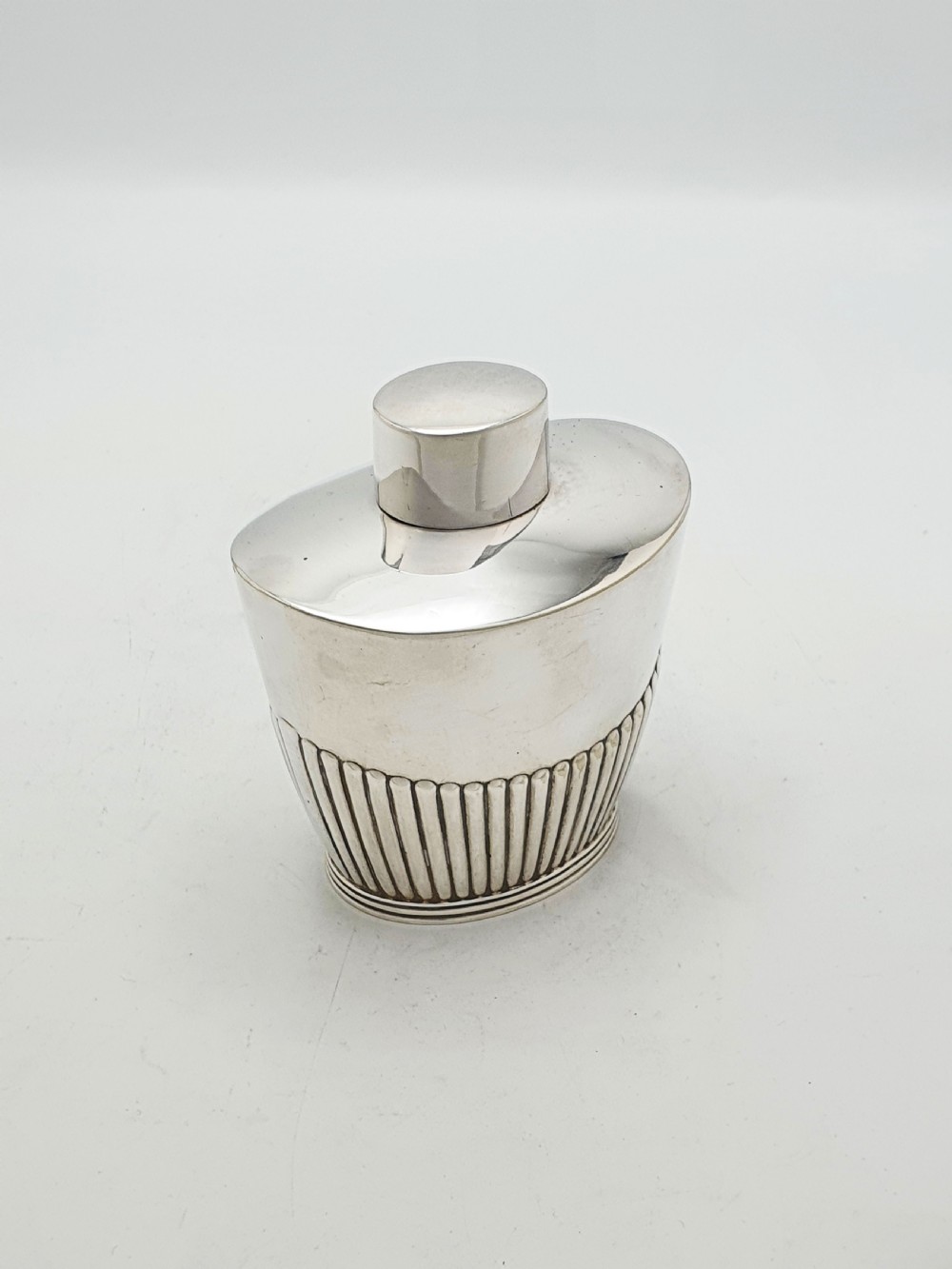 An Edwardian silver-plated tea canister featuring fluted body decoration and a fitted push-on lid. View II