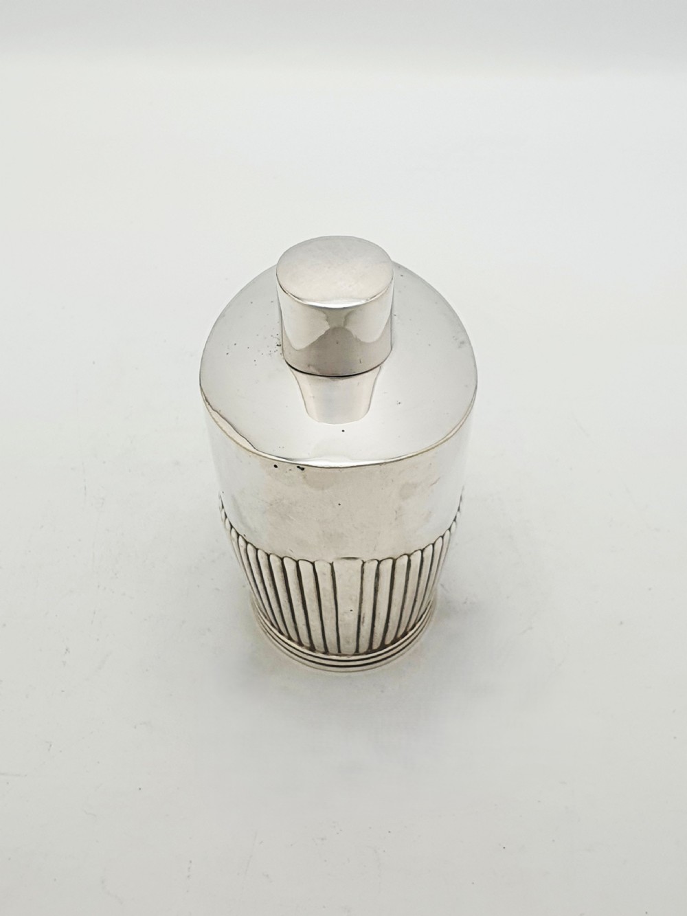 An Edwardian silver-plated tea canister featuring fluted body decoration and a fitted push-on lid. View V