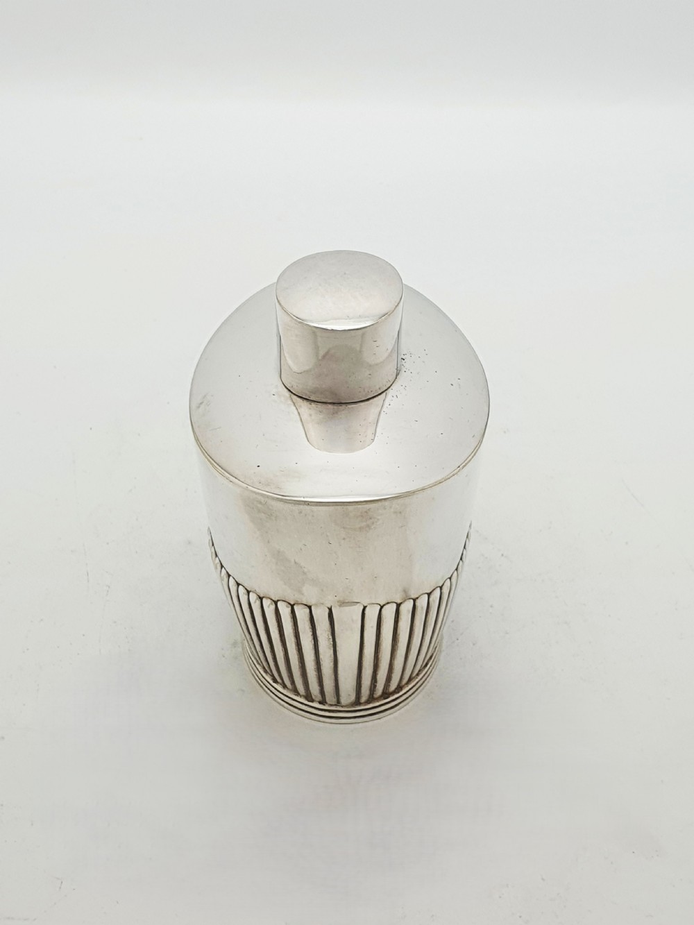 An Edwardian silver-plated tea canister featuring fluted body decoration and a fitted push-on lid. View VII