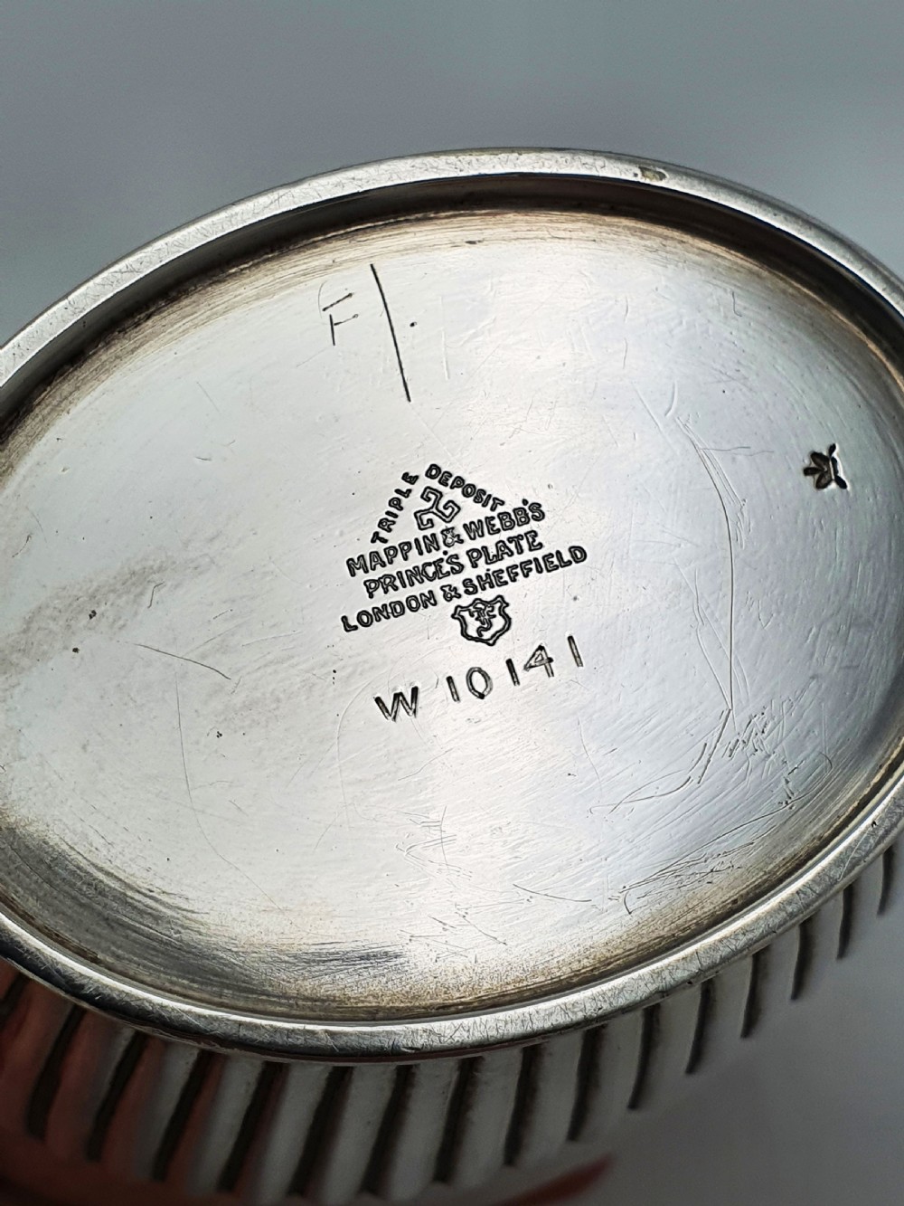 An Edwardian silver-plated tea canister featuring fluted body decoration and a fitted push-on lid. View VIII
