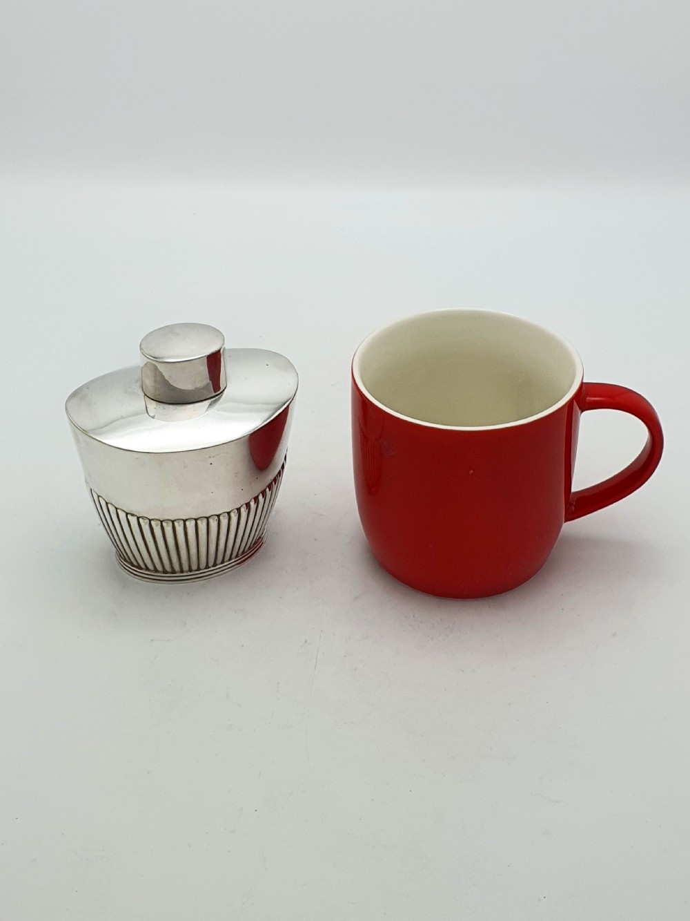 An Edwardian silver-plated tea canister featuring fluted body decoration and a fitted push-on lid. View IX