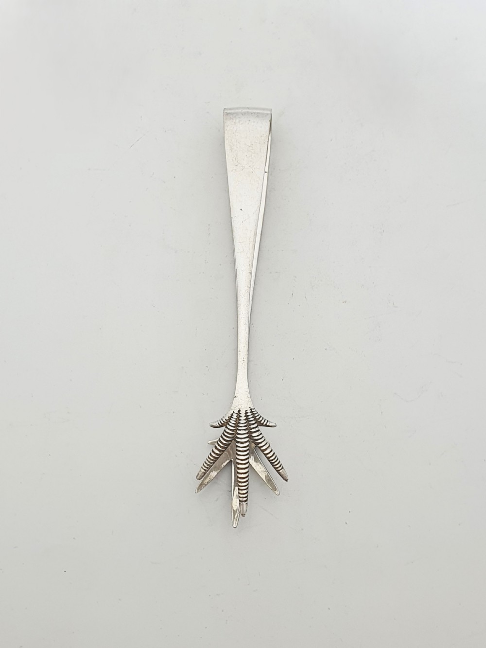 An Edwardian silver-plated ice bucket shaped like a wooden barrel with integrated handles alongside matching claw-foot ice tongs. View VIII
