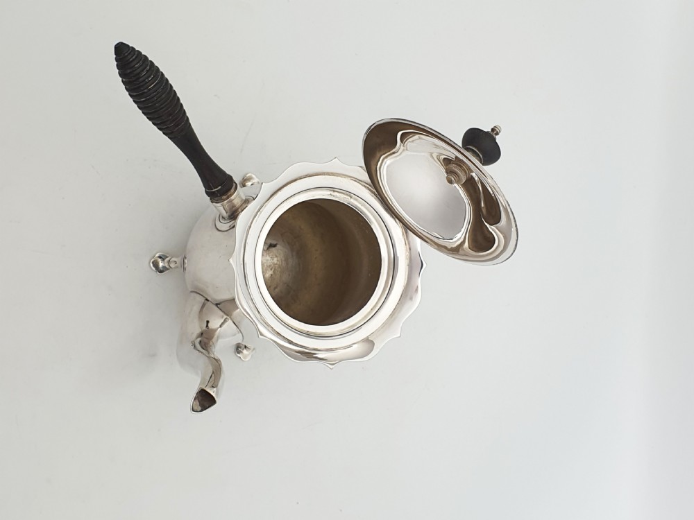 A pair of Edwardian silver cafe au lait pots featuring ribbed wooden side handles, scalloped hinged lids, and carved cabriole feet. View IX